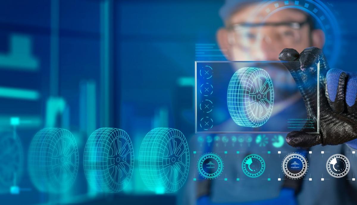 Man holding a glass monitor with virtual tire on it