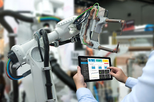 Technician controlling robotic arm with tablet