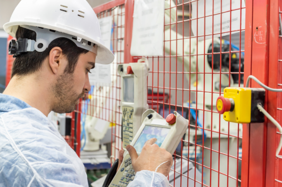 Young man using robotic arm controller