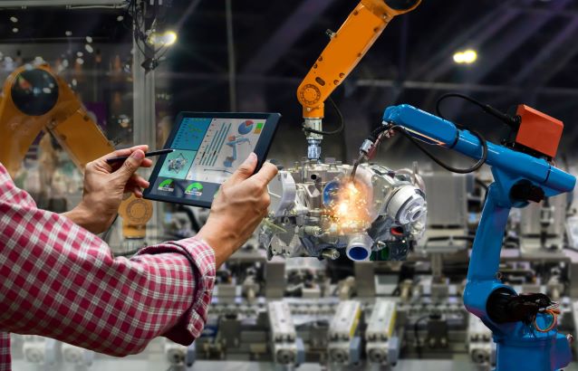 Technician controlling robotic arm with tablet