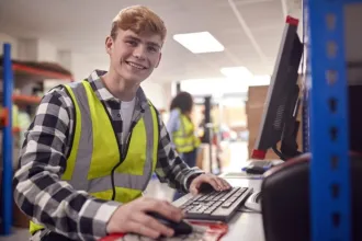 Employee working in a warehouse on a computer terminal 