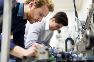 techs working on electronics components