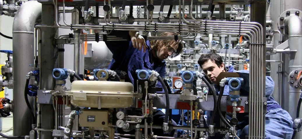 Two technicians at machinery