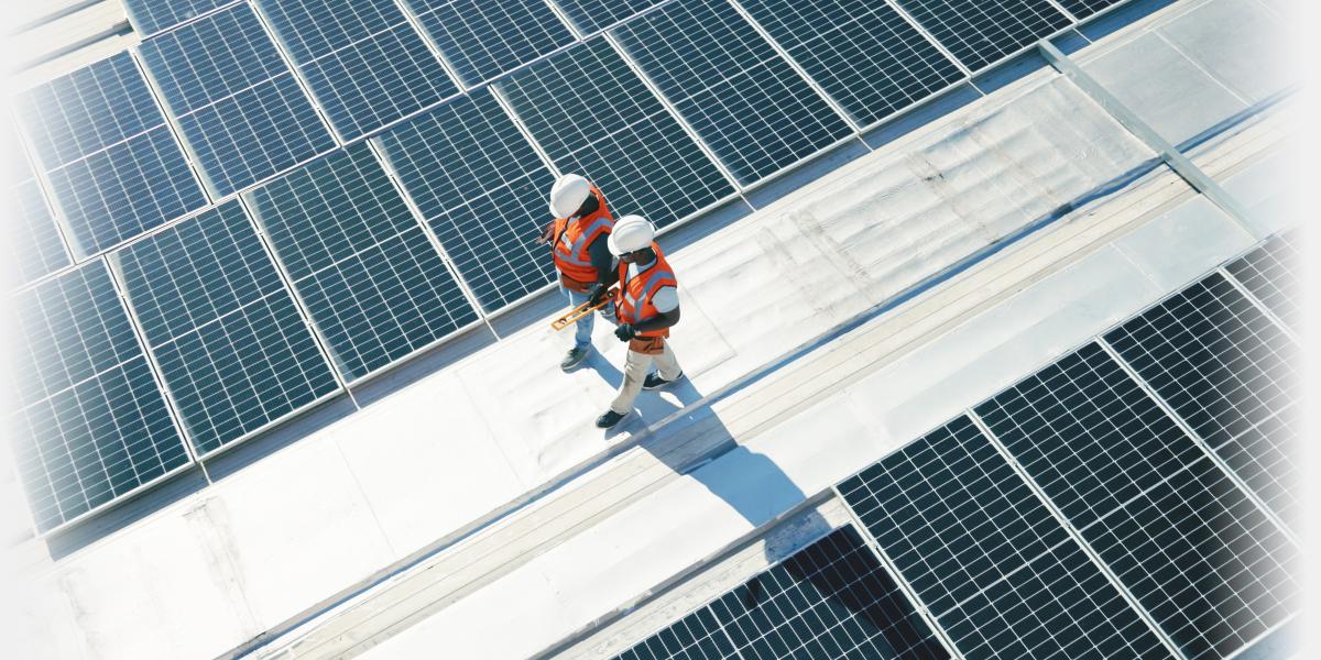 Technicians walking on roof with Solar panels