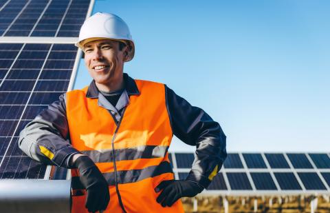 Solar Tech in front of Solar Panels