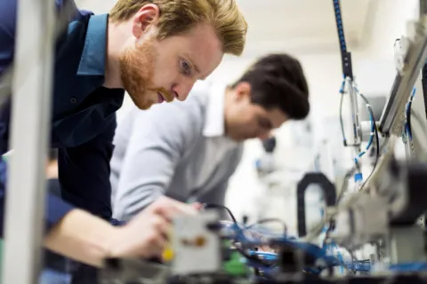 techs working on electronics components