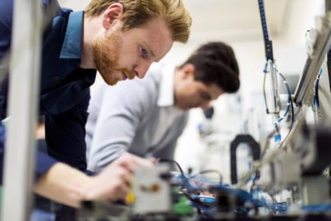 techs working on electronics components