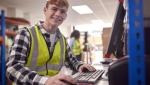Employee working in a warehouse on a computer terminal 