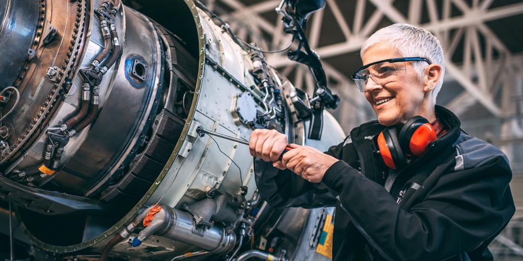 Technician maintaining an airplane jet engine 