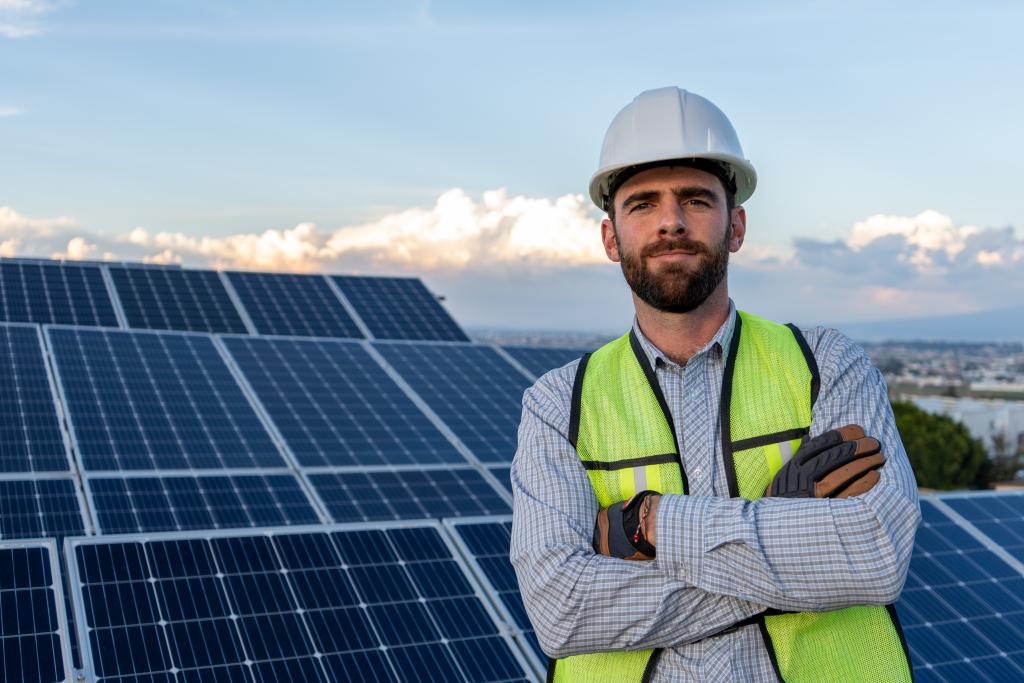 technician in front of solar panels